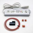 A white rectangular device with wires and a plug, this is the WiFi LED Controller and Plug-in Driver Kit (24V) - Blebox wLightBox + EnoLED ELD, designed for smart lighting control.