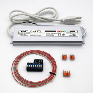 A white rectangular device with wires and a plug, this is the WiFi LED Controller and Plug-in Driver Kit (24V) - Blebox wLightBox + EnoLED ELD, designed for smart lighting control.