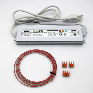 A Non-dimmable Plug-in LED Driver Kit (24V) ~ EnoLED ELD, with a silver driver, white power cord, coiled red-and-white wire, and three small orange wire connectors, is displayed on a white surface.