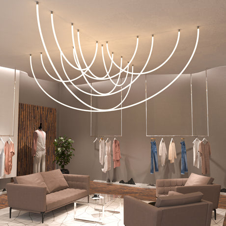 Modern boutique with neutral-toned sofas, a glass coffee table, and stylish clothing displays. Flexible White LED Neon Tube ~ Neon 360 Series provides 360° illumination, forming artistic patterns that enhance the elegant, minimalist interior.