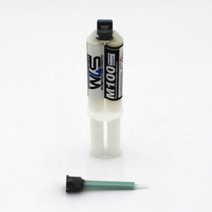 The Marine 2-part Methacrylate Adhesive ~ W4S M100 (25ml 1:1 Mix / B-System) features a blue and white dual-barrel cartridge standing upright, with a green mixing nozzle attachment and black cap placed in front.