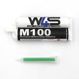 A tube labeled Marine 2-part Methacrylate Adhesive ~ W4S M100 (50ml 1:1 Mix / A-System) is shown above a green mixing nozzle, both set on a white background.