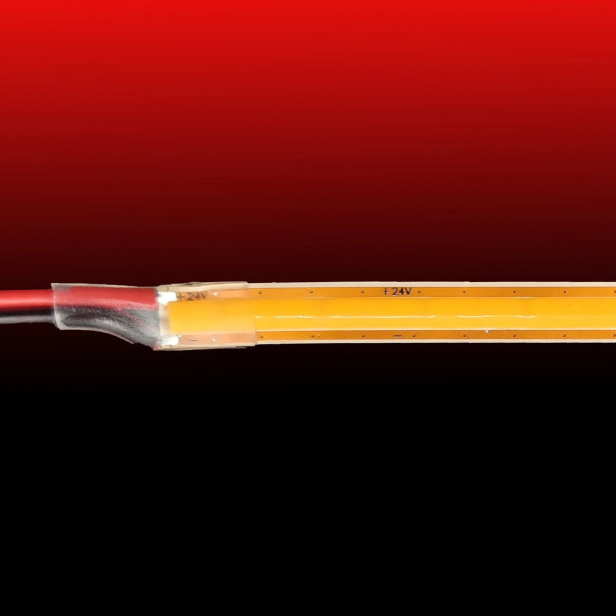Close-up of an Ultra-Thin Flexible COB IP20 High CRI LED Strip (24V) ~ EnoLed Micro Series, showing its ultra-slim profile and power connection.