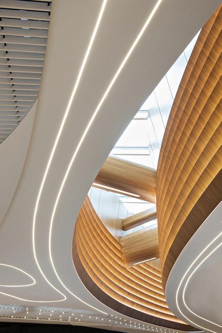 Modern architectural ceiling featuring embedded LED strip lighting with aluminium heat sinks for smooth curves and ambient brilliance