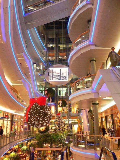 Multi-level shopping mall showcasing RGBWW strip lighting for architectural accents and modern retail illumination.