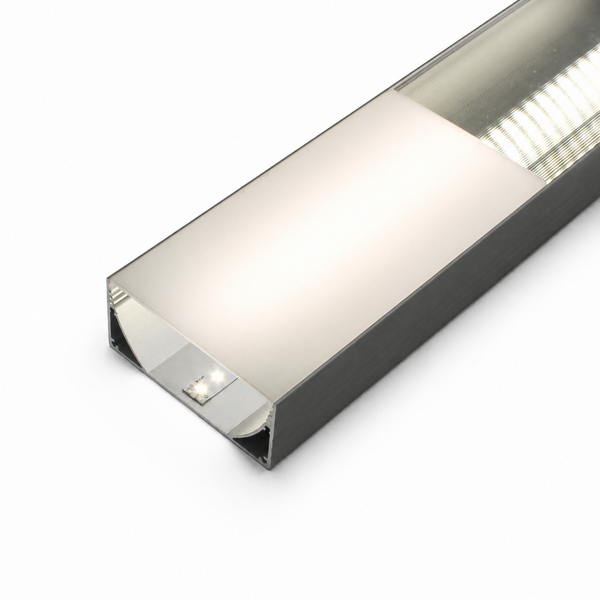 A close-up of a modern rectangular LED light fixture with a metallic frame and a frosted diffuser cover, designed for the Alu-Triangle series profiles and compatible with PLW80N, RPLW80, and RPLW80-FL, emitting a soft, diffused white light.