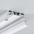 Close-up of the 2" Recessed Easy-Mounting LED Strip Channel ~ Model Phil.v2 Recessed, shown with a white decorative ceiling molding featuring layered grooves, seamlessly installed in a light gray ceiling for smooth LED strip integration.