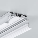 Close-up of the 2" Recessed Easy-Mounting LED Strip Channel ~ Model Phil.v2 Recessed, shown with a white decorative ceiling molding featuring layered grooves, seamlessly installed in a light gray ceiling for smooth LED strip integration.