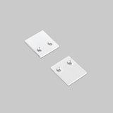 Two small, square, silver End Caps for Pixy20-02 Profile, each featuring two holes, are placed on a plain gray background.