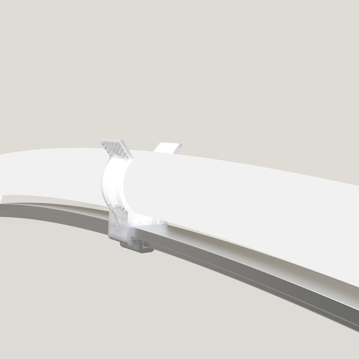 A close-up view of a transparent T-Bar Clip for LED Diffuser Redondo XL securing two white, curved surfaces—such as the Neon Redondo XL—against a light gray background, possibly alongside a T-Section Aluminum Bar for added stability.