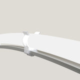 A close-up view of a transparent T-Bar Clip for LED Diffuser Redondo XL securing two white, curved surfaces—such as the Neon Redondo XL—against a light gray background, possibly alongside a T-Section Aluminum Bar for added stability.