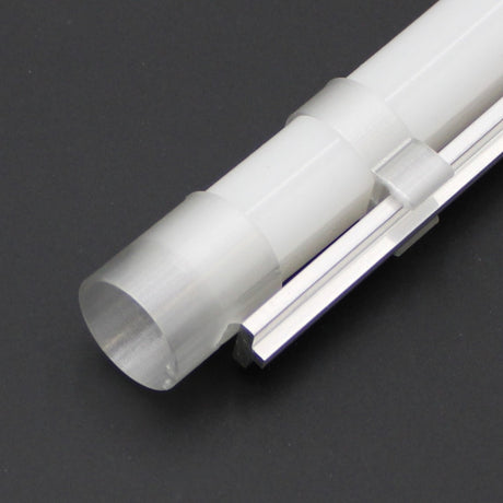 A close-up of the T-Bar Clip for LED Diffuser Redondo XL attached to the side of a translucent plastic tube, set against a dark background.