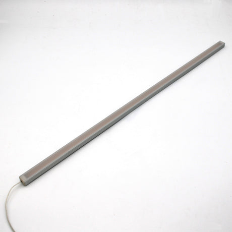 The White Universal Surface-mount Waterproof Outdoor LED Lighting Fixture (24V) from the Roma Series is a slim, rectangular, dotless bar with a white cord, shown diagonally on a white background—ideal for outdoor use.