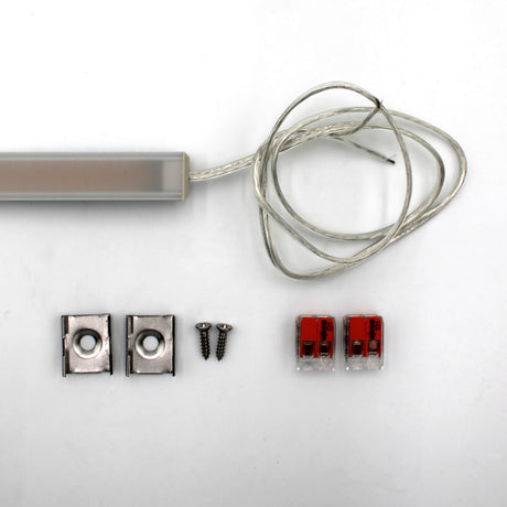 The White Universal Surface-mount Waterproof Outdoor LED Lighting Fixture (24V) ~ Roma Series comes with a transparent cable, two metal mounting brackets, screws, and wire connectors—ideal for outdoor surface-mount lighting.