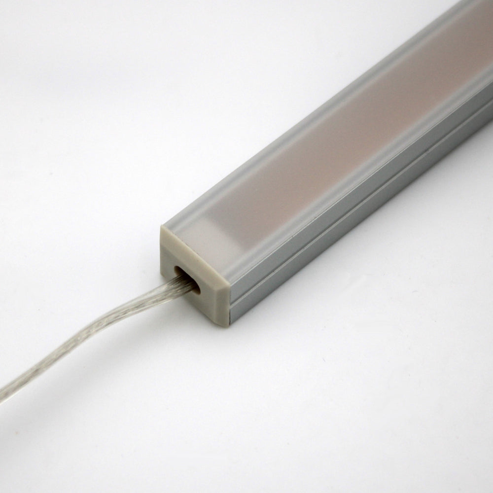 A close-up of the White Universal Surface-mount Waterproof Outdoor LED Lighting Fixture (24V) ~ Roma Series, featuring a rectangular dotless LED bar with a frosted cover and wire, set against a plain white background.