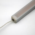 A close-up of the White Universal Surface-mount Waterproof Outdoor LED Lighting Fixture (24V) ~ Roma Series, featuring a rectangular dotless LED bar with a frosted cover and wire, set against a plain white background.
