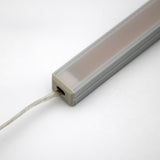 A close-up of the White Universal Surface-mount Waterproof Outdoor LED Lighting Fixture (24V) ~ Roma Series, featuring a rectangular dotless LED bar with a frosted cover and wire, set against a plain white background.