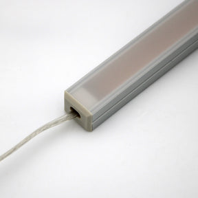 A close-up of the White Universal Surface-mount Waterproof Outdoor LED Lighting Fixture (24V) ~ Roma Series, featuring a rectangular dotless LED bar with a frosted cover and wire, set against a plain white background.
