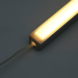 The White Universal Surface-mount Waterproof Outdoor LED Lighting Fixture (24V) ~ Roma Series features a translucent cover, dotless light, and an electrical cord at one end, shown against a plain dark background.