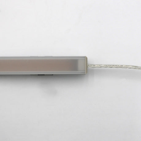 A close-up of the White Universal Surface-mount Waterproof Outdoor LED Lighting Fixture (24V) ~ Roma Series, featuring a slim, rectangular frosted bar with a clear cord on the right, displayed against a white background.