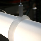A close-up of the Mounting Clip for 2.56" Round Profiles shows it suspending a cylindrical frosted fixture by a thin cable, with a softly blurred background.