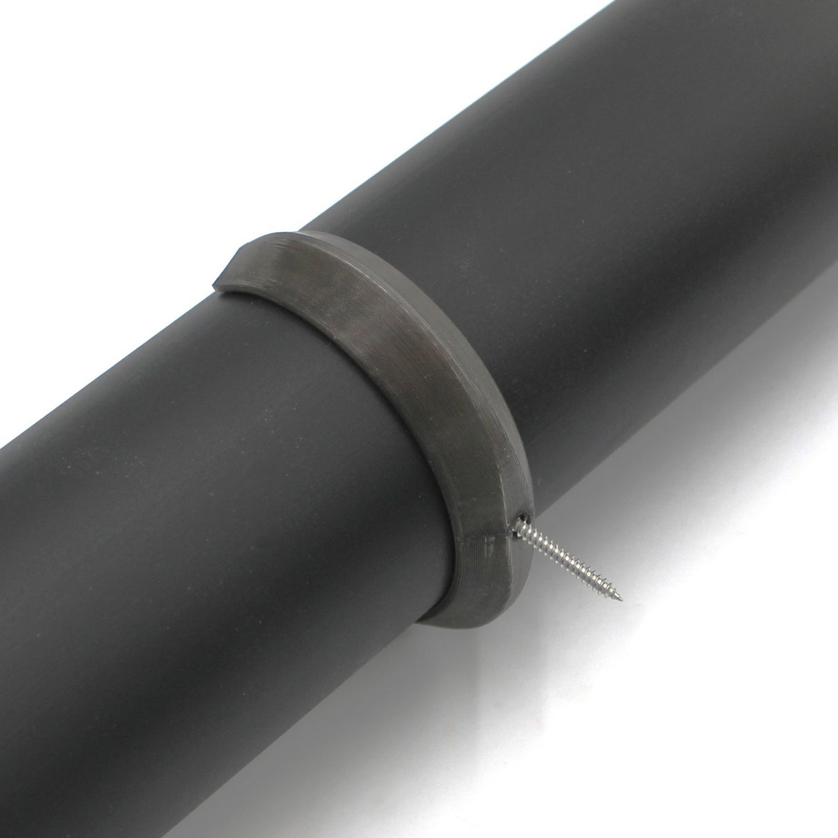 A Mounting Clip for 2.56" Round Profiles is attached to a black cylindrical pipe, secured by a metal clamp with a screw partially inserted into the pipe.