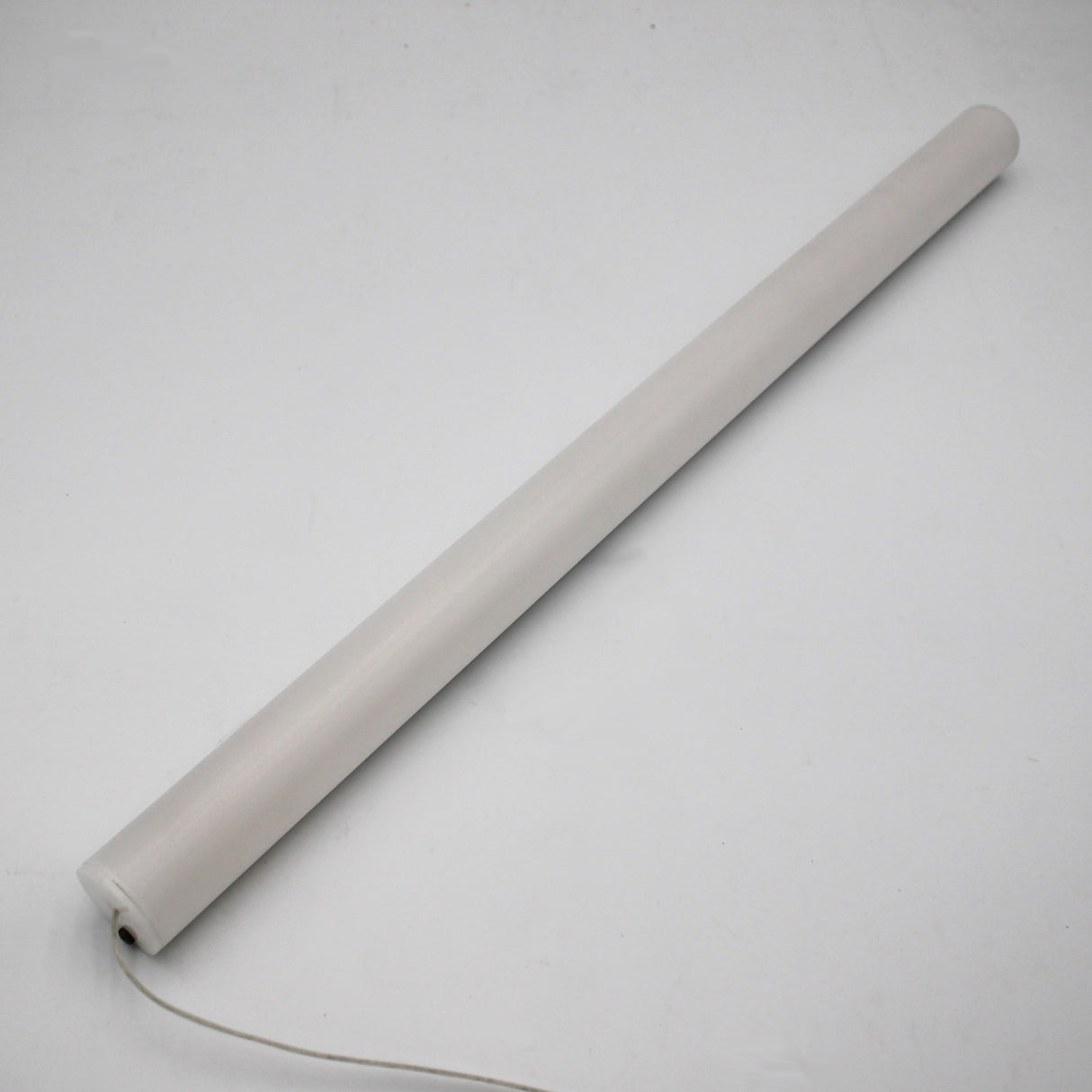 The 1.5" White Surface-mount LED Tube Lighting Fixture (24V) from the Sierra38 Series is a sleek, cylindrical plug-and-play light with an end cord, shown positioned diagonally on a plain white background.