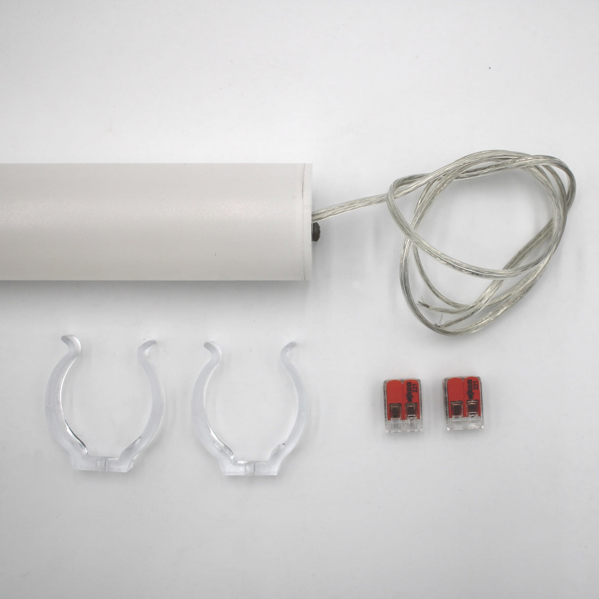 The Sierra38 Series 1.5" White Surface-mount LED Tube Lighting Fixture (24V) is shown on a white background with a clear cord, two clear mounting clips, two red and gray wire connectors, and mounting hardware.