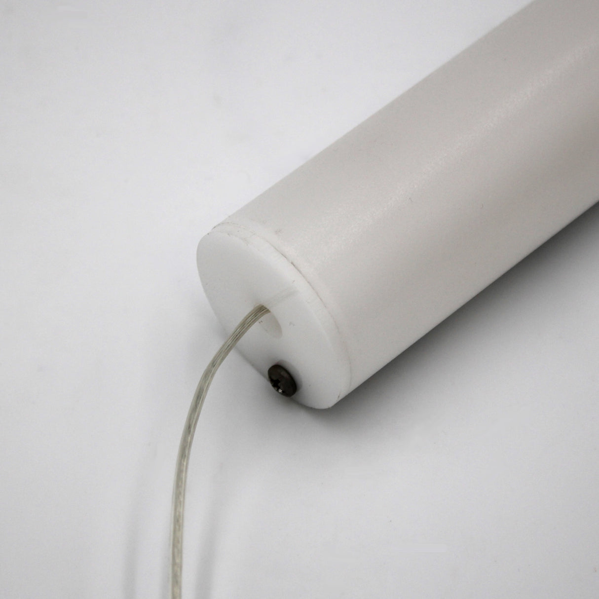 A close-up of the 1.5" White Surface-mount LED Tube Lighting Fixture (24V), Sierra38 Series, shows its cylindrical plug-and-play design with a transparent wire at one end, set against a plain white background.
