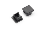 Two black End Caps for Smart10 Profile are displayed on a white background—one upright showing its smooth exterior, the other flipped to reveal four interior support pegs. Both are made of plastic and designed to fit the Smart10 lighting fixture.