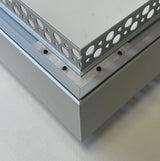 A close-up of a perforated metal sheet with round holes in varying sizes, secured by black screws to the corner of a solid TL-041 profile frame and supported by an L Bracket for TL-041 Profile.