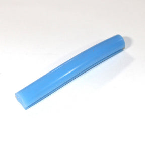 A small, cylindrical blue plastic tube lies on a white surface, resembling the Marsella Flexible Color Diffusers for LED Strip used in architectural lighting.