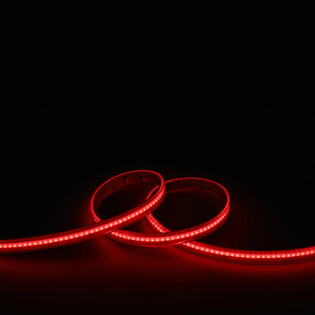 The RGB+CCT COB IP67 High CRI LED Strip (24V) from the EnoLED UniColor Series is shown coiled against a black background, emitting a bright, seamless glow.