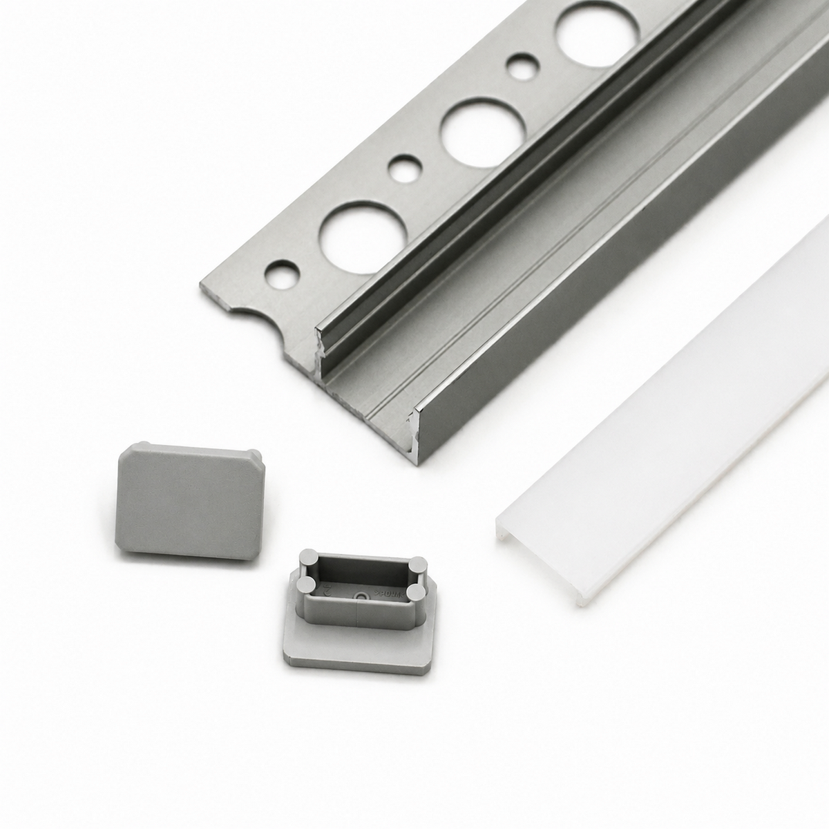 Tile Edge LED Strip Light Channel Kit ~ Model Uni-Tile12 180Deg shown: metal channel with circular holes, frosted plastic cover, and two gray end caps on a white surface—ideal for recessed lighting or tile edge LED installs.