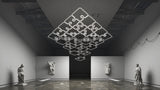 A large, puzzle-shaped 0.51″ Suspended/Surface Mount Bendable LED Channel ~ Model Bend8 fixture suspended from the ceiling in a gallery space containing classical statues.