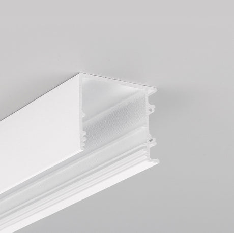 Close-up of the 1.3" Surface Mount Side-Lighting LED Channel (Model Vario30-03), a white rectangular channel with grooves for housing LED strip lights in architectural lighting. Set against a plain light gray ceiling background.