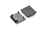 Two black plastic parts—a textured end cap and a flat base with four pegs—are shown for the End Cap for Vario30-03 Profile lighting fixture, featuring several small markings or symbols on their surfaces.