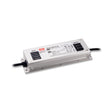 A rectangular white Compact IP67 Waterproof LED Driver with Selectable Voltage from the Meanwell XLG Series, featuring black input and output cables, visible technical details, and a sturdy gray metal casing, is displayed on a white background. This versatile LED driver from the trusted Meanwell XLG Series offers dependable performance for various LED power supply needs.