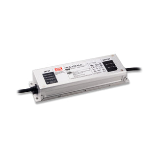 A rectangular white Compact IP67 Waterproof LED Driver with Selectable Voltage from the Meanwell XLG Series, featuring black input and output cables, visible technical details, and a sturdy gray metal casing, is displayed on a white background. This versatile LED driver from the trusted Meanwell XLG Series offers dependable performance for various LED power supply needs.