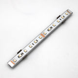 A silver Yukon LED profile light strip with multiple small LEDs on a metallic bar is mounted on a plain white background using the Surface Mount for Yukon Profile accessories.