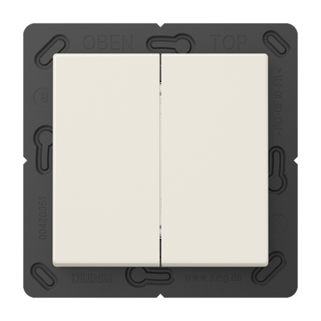 The Casambi 4-Channel Wireless Radio Transmitter (Model Jung BLE A 595) is a white double light switch with a black frame, labeled OBEN and TOP at the top and JUNG at the bottom. It supports energy harvesting tech. The background is gray.