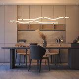 Two parallel, wavy Double-Sided Bendable LED Channel ~ Model Arc12 Duo pendant lights hanging above a dining table in a modern kitchen.