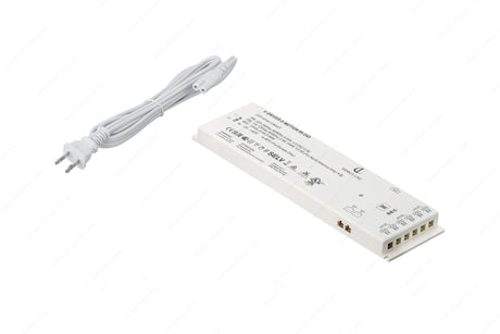 A white Dimmable Plug-In LED Driver (24V) from the X-Driver D-Motion Series with labeled terminals and a two-prong power cord, ideal for powering smart LED drivers or D-Motion luminaires, shown on a white background.