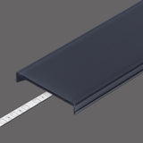 A dark blue LED Channel Cover ~ C8 Click with slot, partially open to show a white adhesive strip under it, displayed on gray; compatible with Pixel33 profiles and featuring a clip-in design.