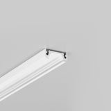 A white decorative molding or cornice, such as the Surface Mount LED Strip Channel ~ Model Surface10, is attached near the corner where the wall meets the ceiling, against a plain light gray background.