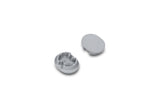 Two small, gray, oval plastic D End Caps for the Arc12 Duo Profile lighting fixture are shown; one end cap is positioned with the interior side facing up to reveal small ridges, while the other displays its smooth exterior surface. The items are set against a white background.