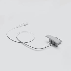 A white cable links the small Cut & Connect End Cap for Berlin Profile to a larger gray, three-pronged component, all on a plain light gray background—ideal for easy linear lighting installations.