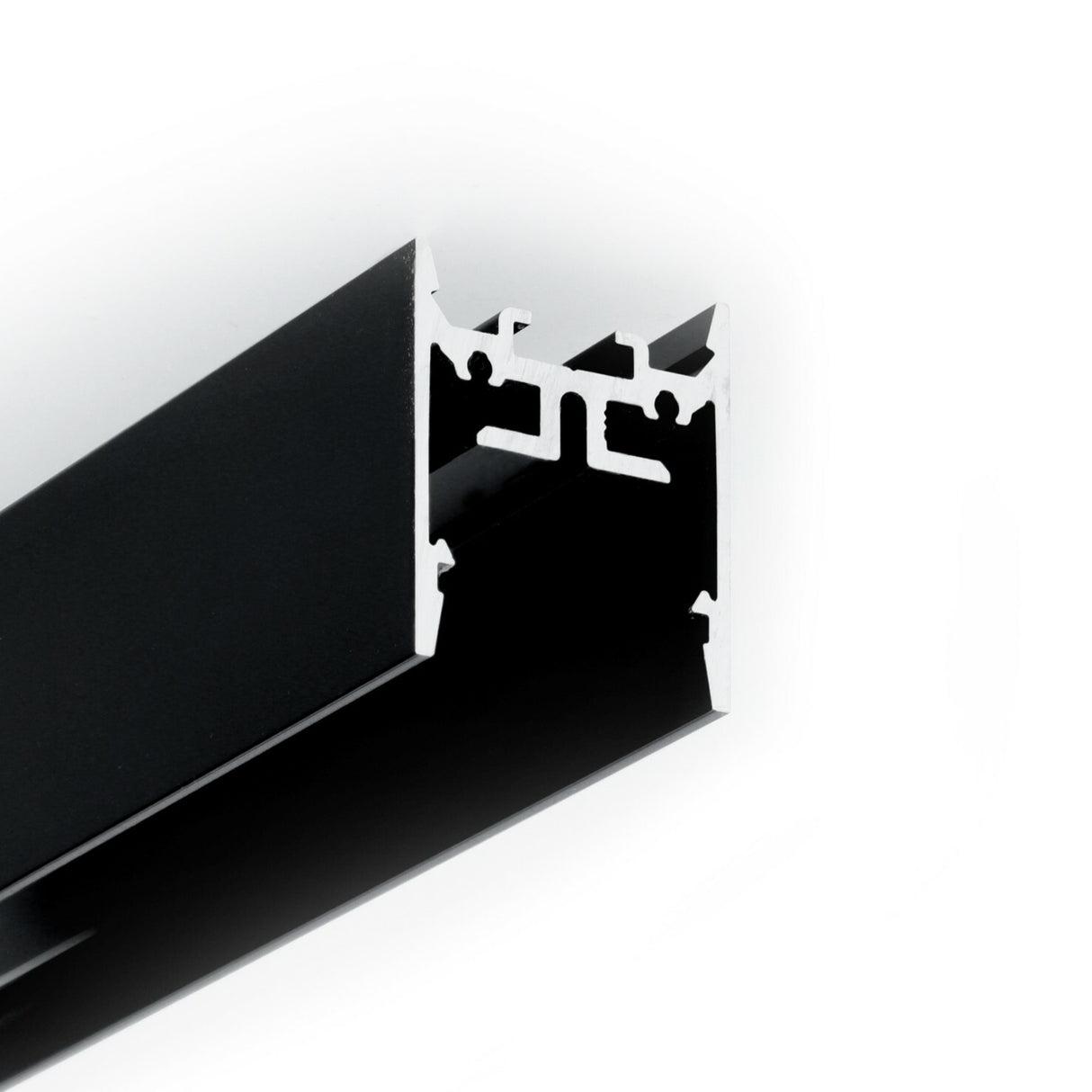Close-up of the 1″ Suspended/Surface Mount LED Channel ~ Model Pixy20-01, a black aluminum extrusion profile with a silver cross-section that highlights its angular, geometric interior structure against a white background—ideal for linear lighting applications.