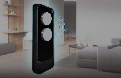 A close-up of the Smart Magnetic Accessory for openSensor ~ twinMagnet by Blebox with two round buttons emitting signal waves, set against a sleek living room featuring advanced window tilt detection.