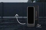 A Smart Magnetic Accessory for openSensor, the twinMagnet by Blebox, is shown in front, with an arrow highlighting a closed modern gate in the background. The wet ground suggests recent rain.
